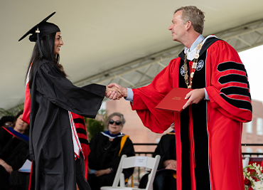 Image of Marist student shaking hands with President Weinman during Commencement.
