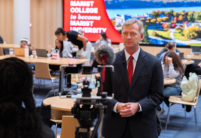 Image of President Weinman doing a media interview.