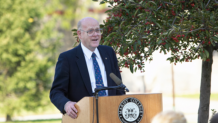 Dr. Foy speaking at the 2003 dedication of the Foy Town Houses