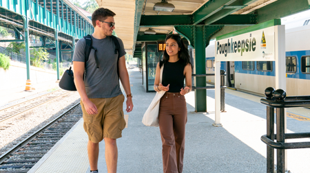 Image of a students walking and having a conversation at the Poughkeepsie train station.