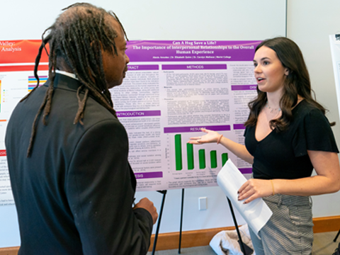 Image of a student presenting research.