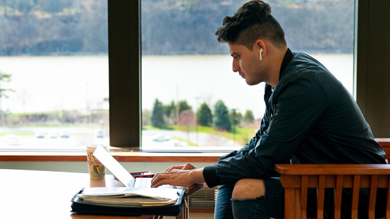 Image of a student studying in the library.
